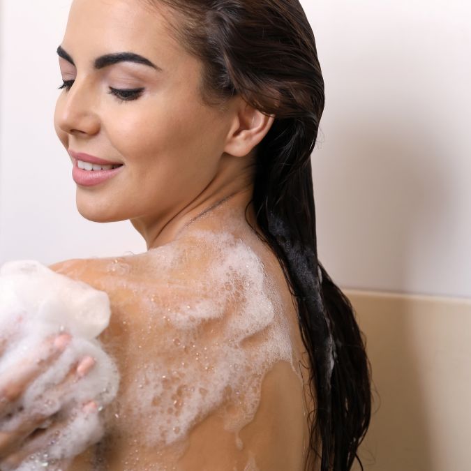 Andromeda shampoo and body wash floral scent lancolia woman lathering product on skin